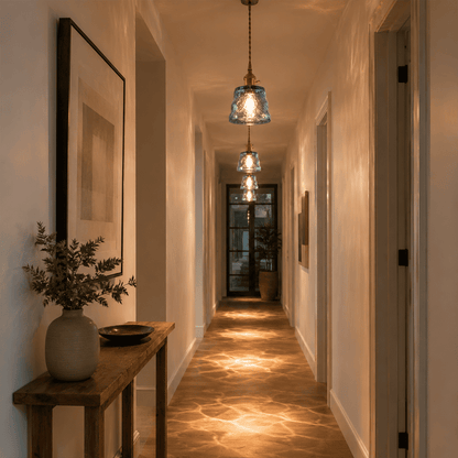Blue glass pendant lights hallway warm light pattern on floor corridor