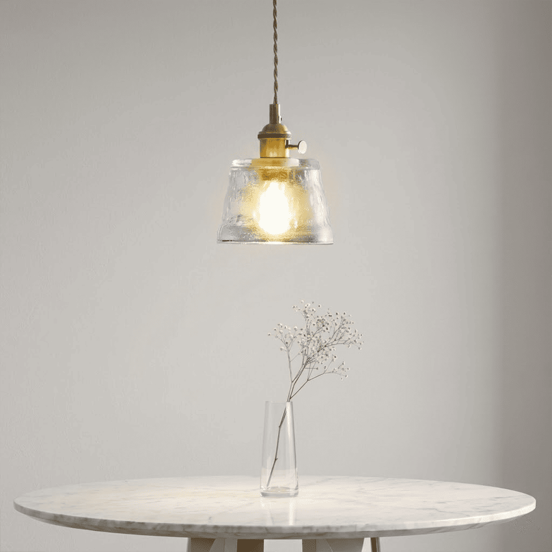 Clear Nordic Cup pendant light above white marble dining table minimal
