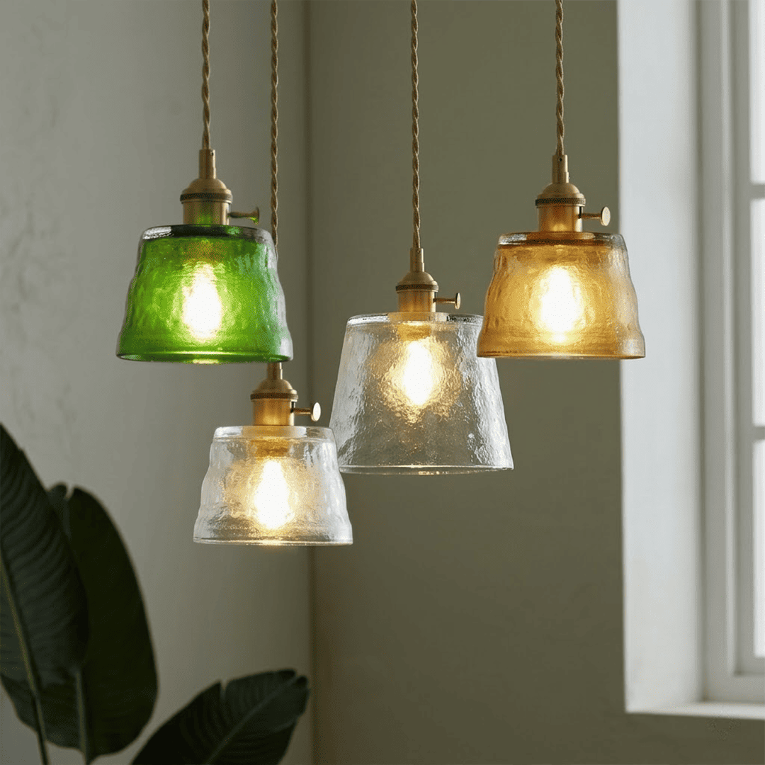 Amber green clear Nordic Cup pendants grouped above round dining table
