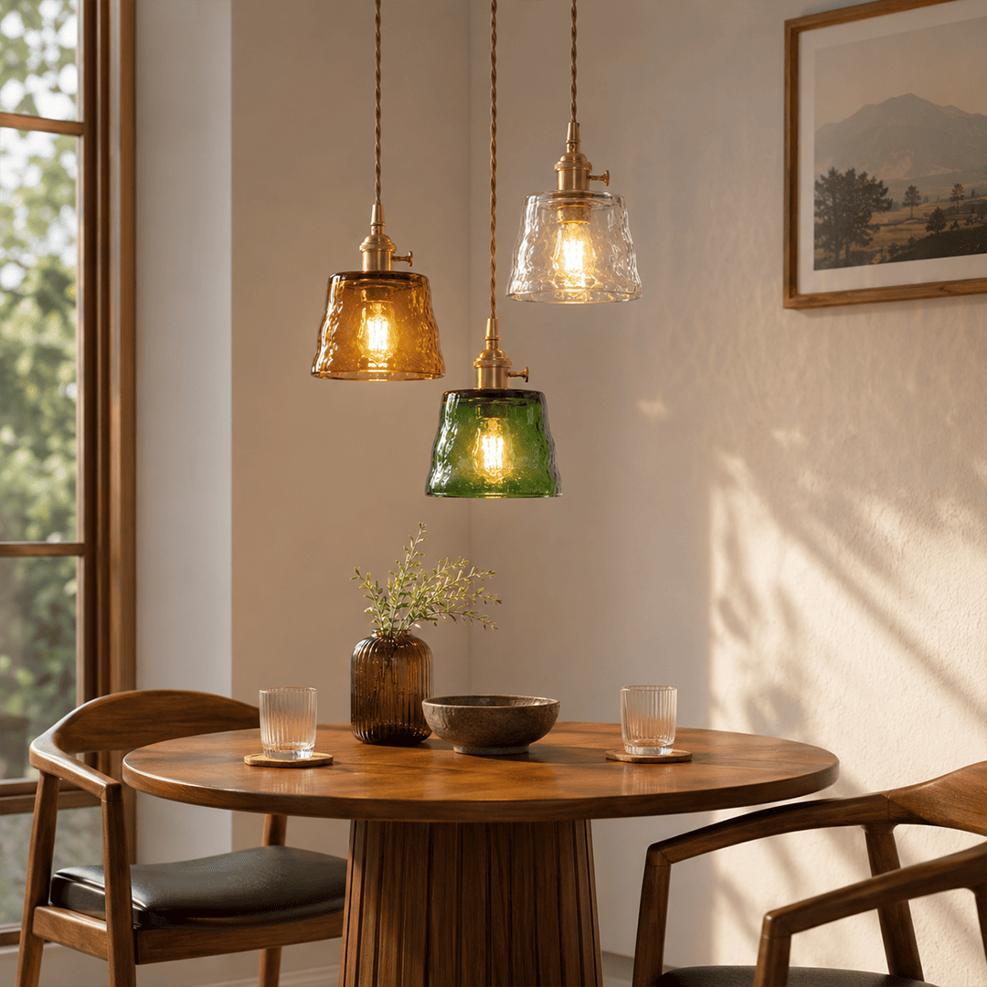 Amber green clear Nordic Cup pendants grouped above round dining table
