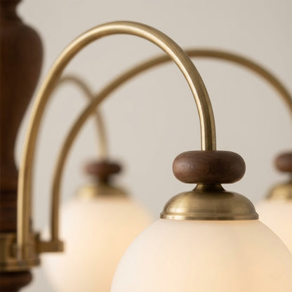 Windsor walnut chandelier  above dining table warm glowing light living room