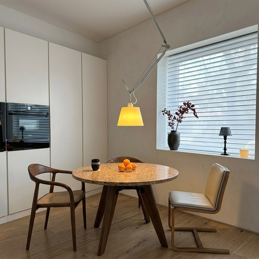 Tate industrial chandelier loft apartment dining table exposed brick walls aluminum frame parchment warm interior