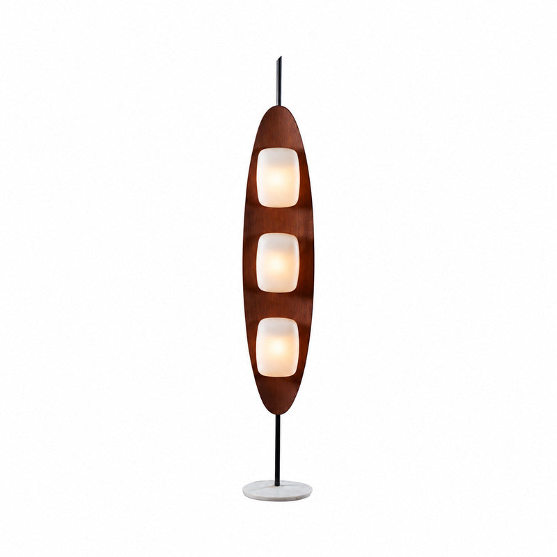 Tavola wood floor lamp with a curved teak surfboard frame and three soft shades glowing warm in a living room