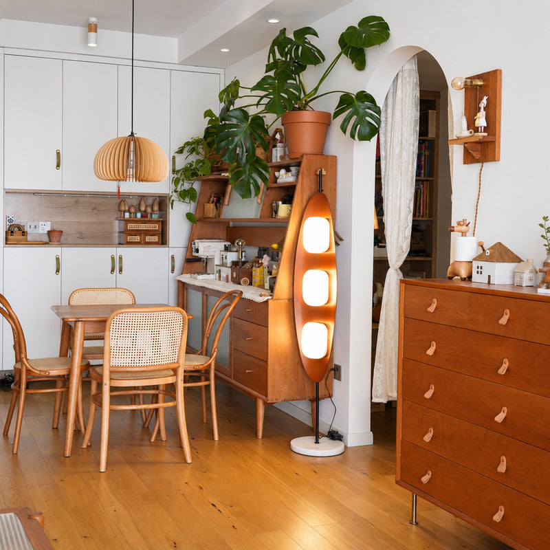 Tavola teak wood floor lamp filling a living room corner with a soft warm glow