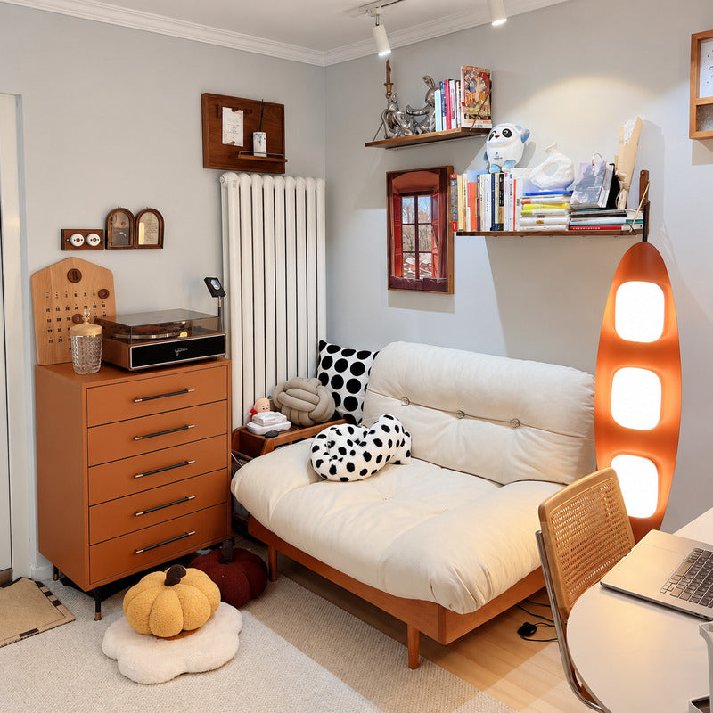 Tavola wood floor lamp standing beside a sofa as a warm sculptural centerpiece in a living room