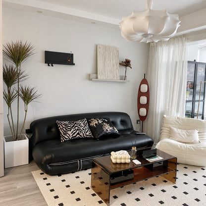 Tavola teak wood floor lamp filling a living room corner with a soft warm glow