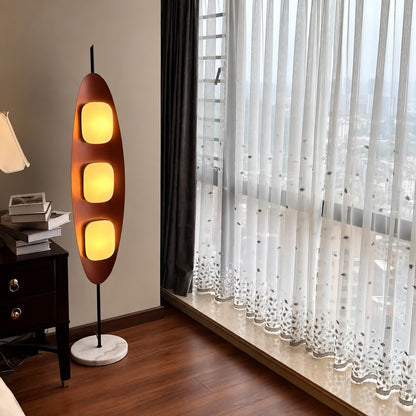 Tavola teak wood floor lamp adding a warm mid-century touch to a home office corner