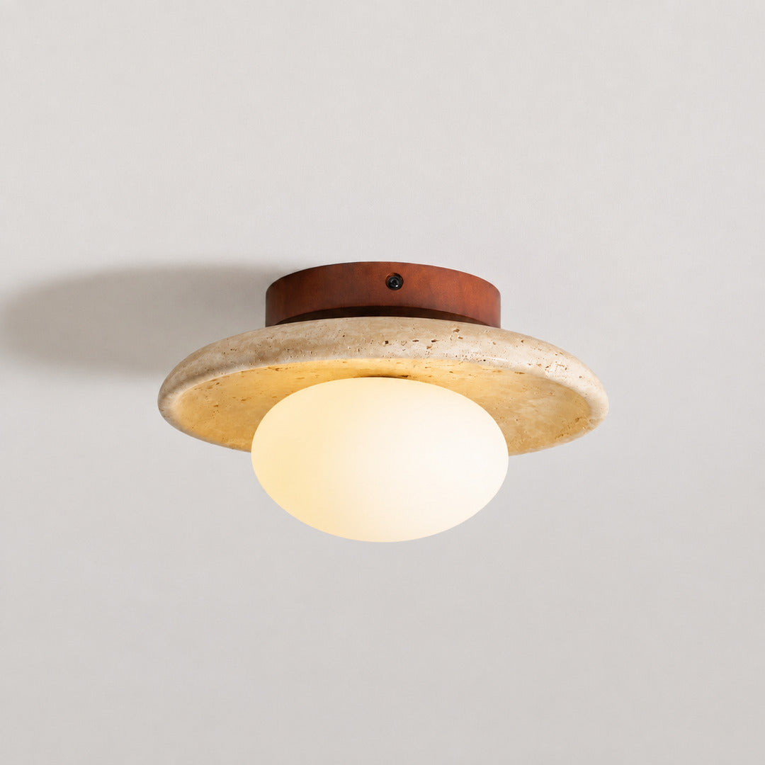 Tondo travertine ceiling light illuminated warm moonlit ambient glow travertine stone glass diffuser white background