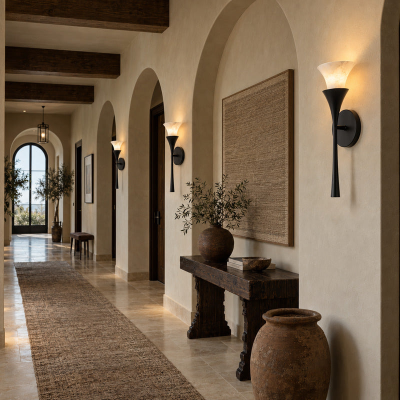 Row of Torcia alabaster wall sconces casting warm uplight along a modern hallway