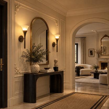 Two Torcia alabaster wall sconces flanking a fireplace for a symmetrical warm uplight