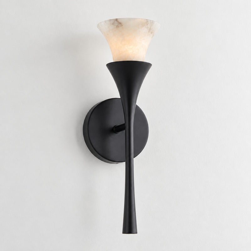 Matte black Torcia alabaster wall sconce as a bold accent on a living room feature wall