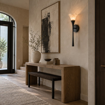 Torcia alabaster wall sconce welcoming guests with a warm torch-style glow in an entryway