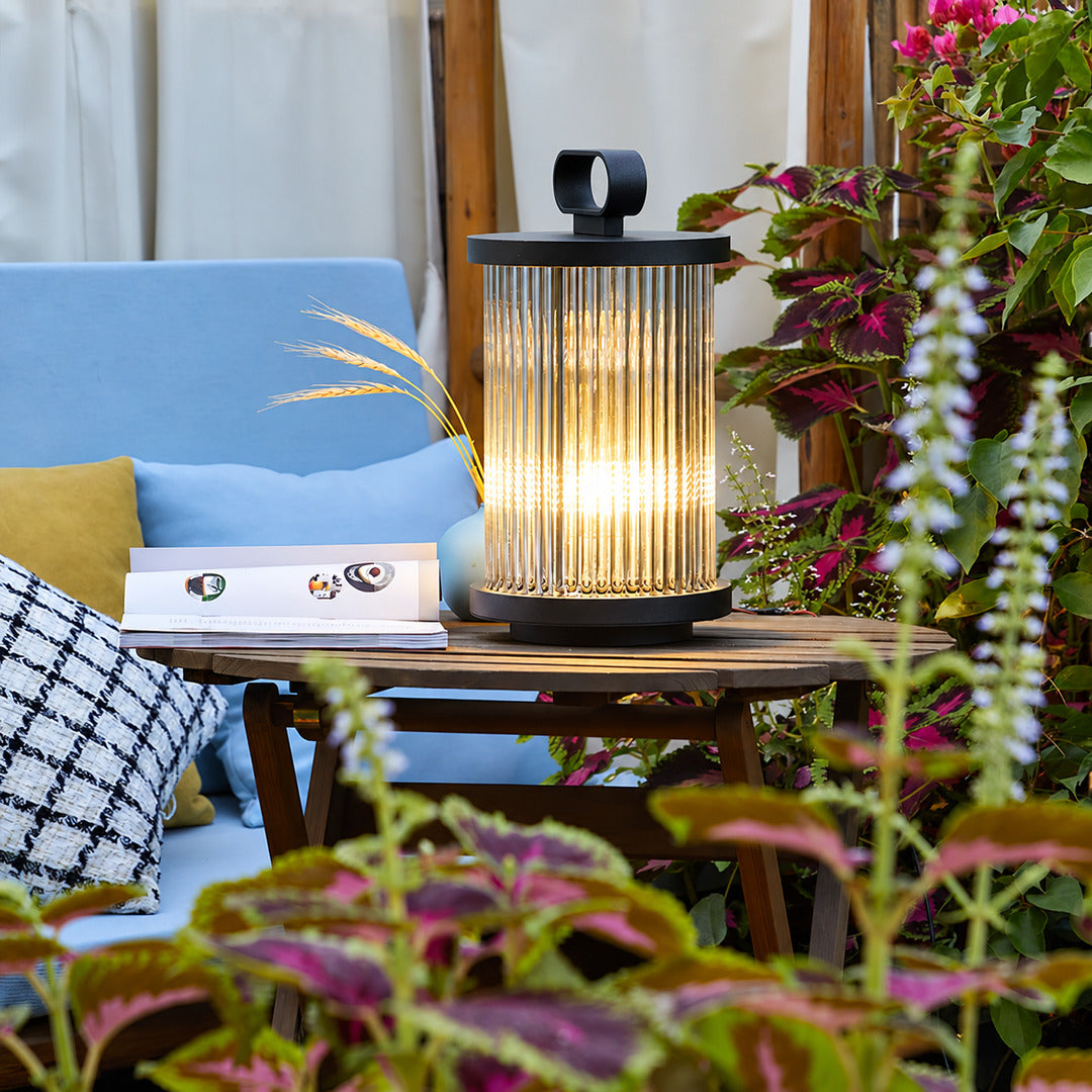 Row of Torre outdoor garden lights lighting a restaurant garden terrace at night