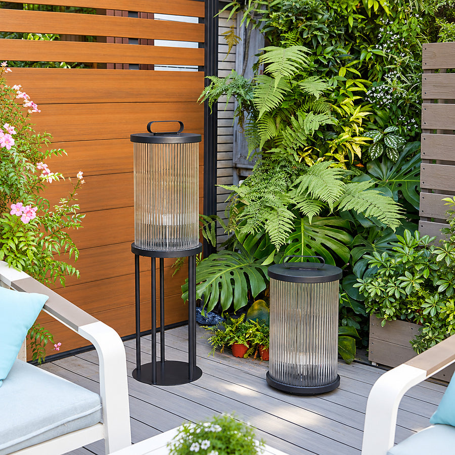 Tall Torre outdoor garden light standing as a floor lantern on a backyard deck