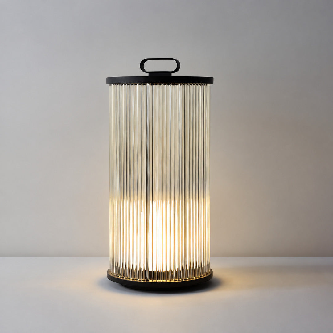 Medium 23.6-inch hardwired Torre outdoor garden light beside a patio seating area