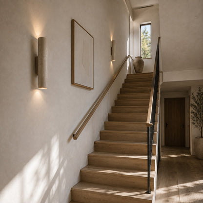 Torre travertine wall sconce staircase stairwell warm glow travertine stone column American home lifestyle interior styled