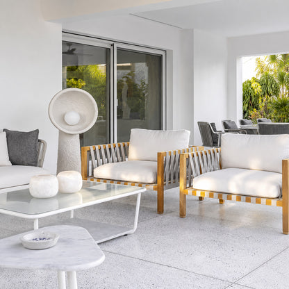 Totem sculptural floor lamp filling a living room corner with a soft warm glow