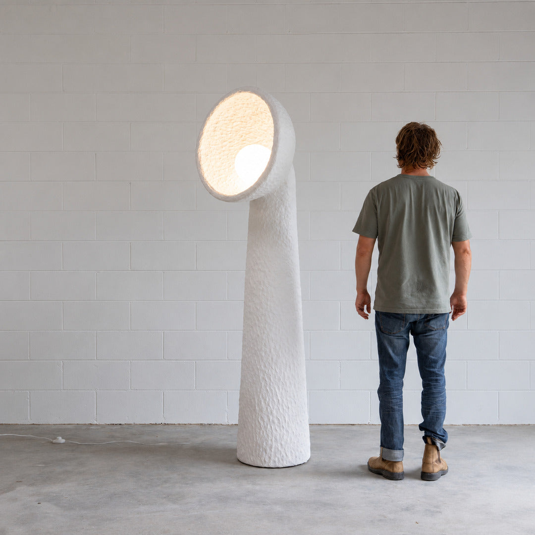 Totem sculptural floor lamp complementing a clean modern minimalist living room