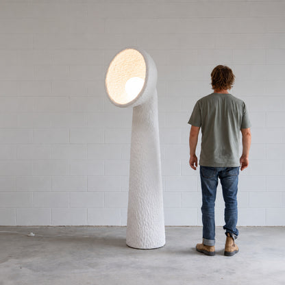 Totem sculptural floor lamp complementing a clean modern minimalist living room