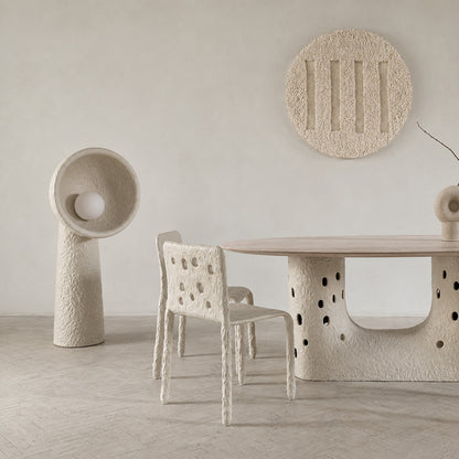 Totem sculptural floor lamp lighting a modern office lounge with a soft sculptural glow
