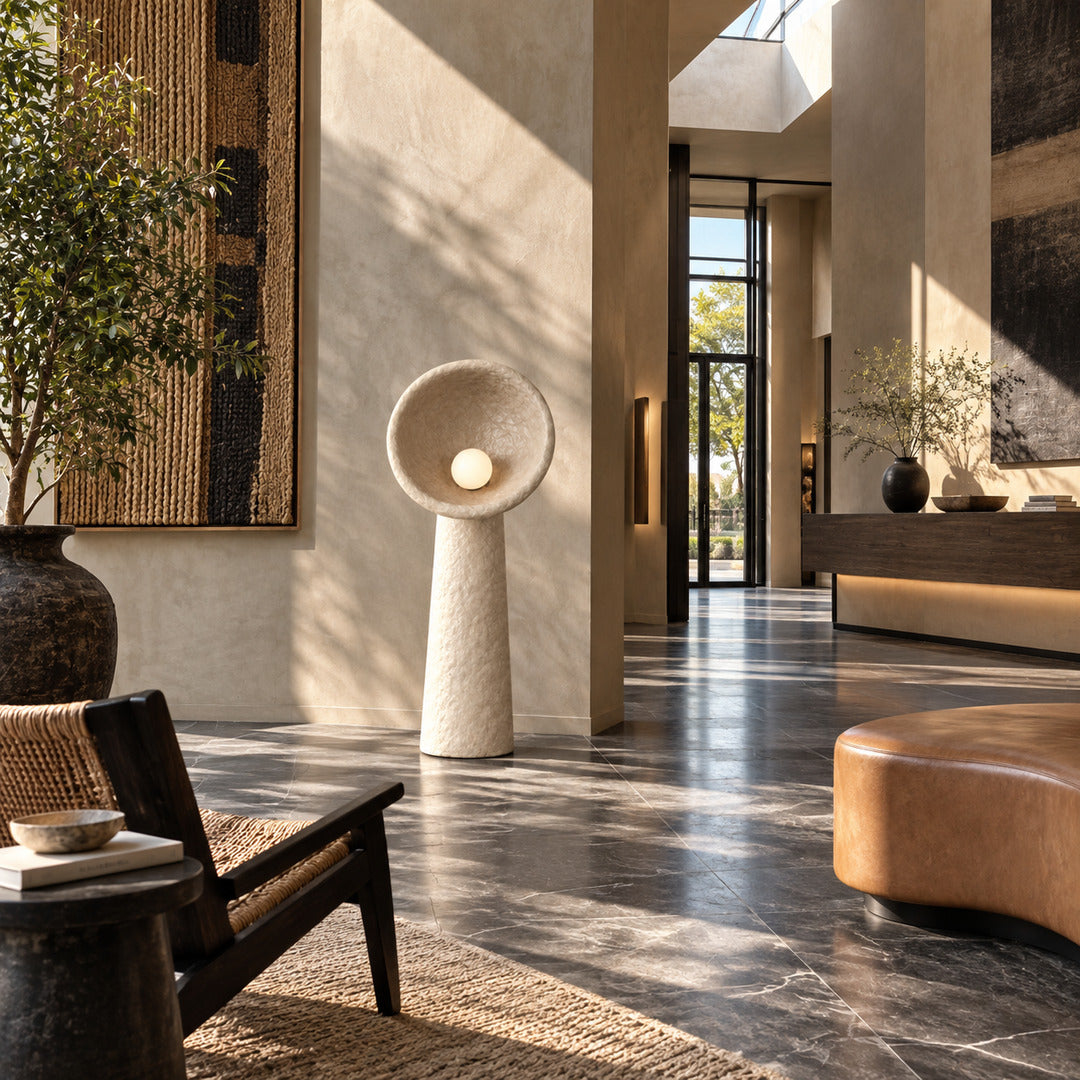 Totem sculptural floor lamp filling a living room corner with a soft warm glow