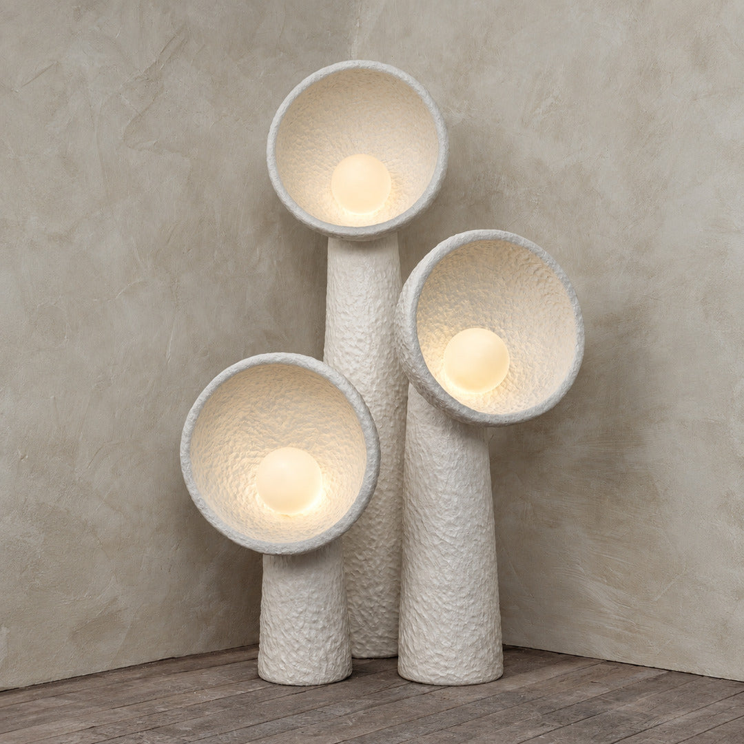 Soft warm glow radiating from the orb of the Totem sculptural floor lamp