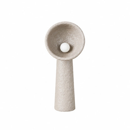 Totem sculptural floor lamp with a stacked textured base and a soft glowing orb in a living room