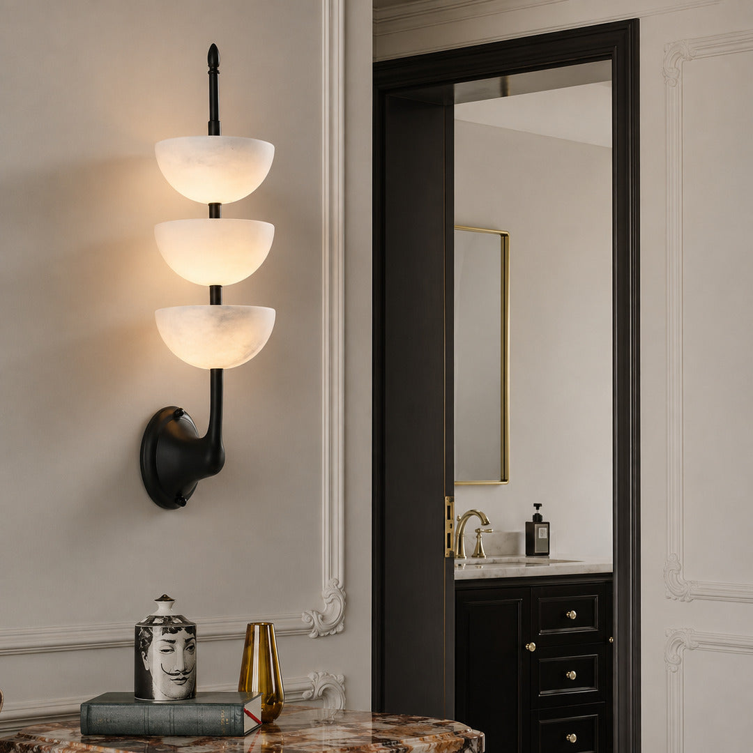 Brass Trio alabaster wall sconce adding a warm natural-stone accent to a dining room wall