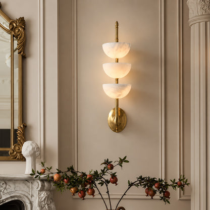 Trio alabaster wall sconce as a warm sculptural accent on a modern living room wall