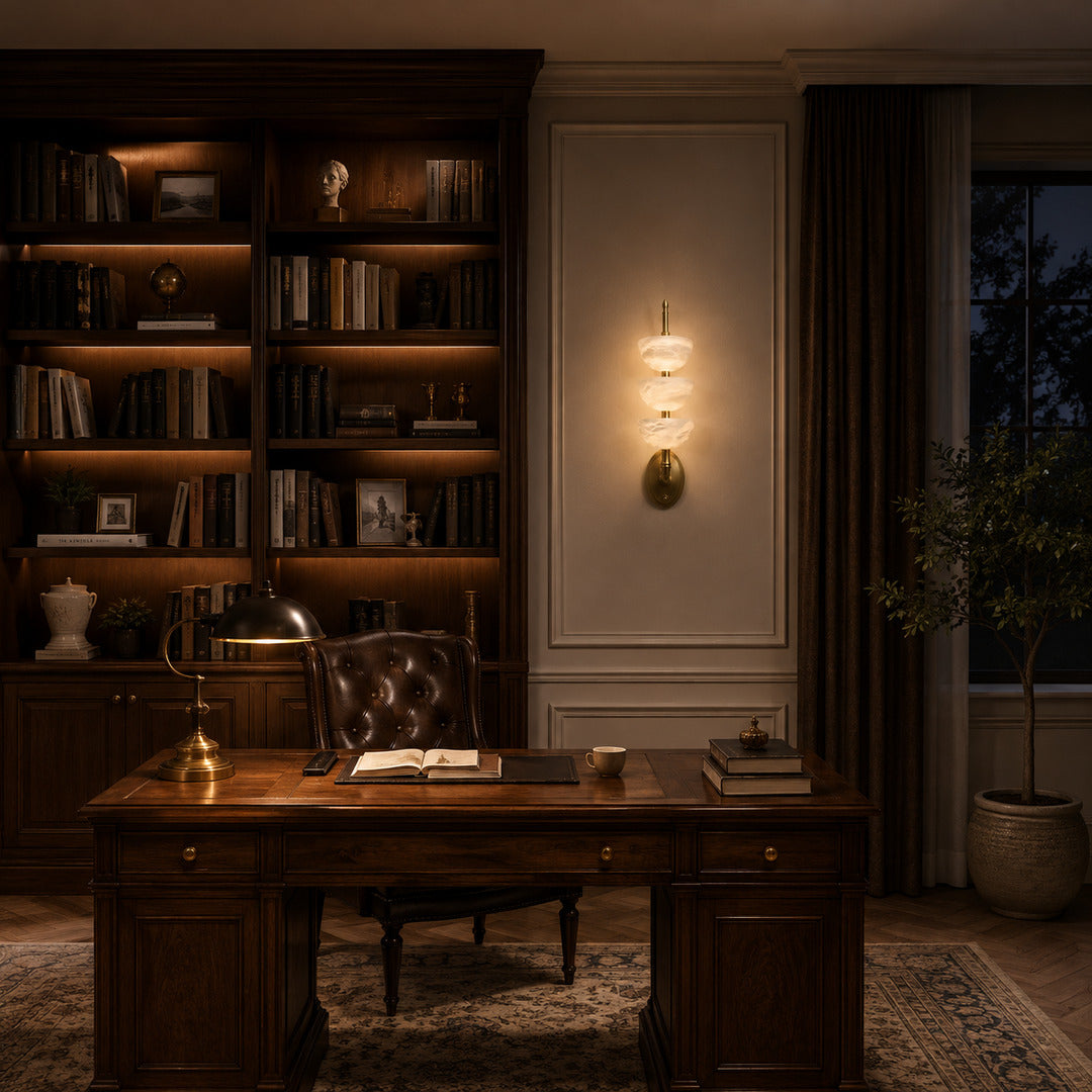 Warm evening glow of the Trio alabaster wall sconce highlighting the stone veining after dark