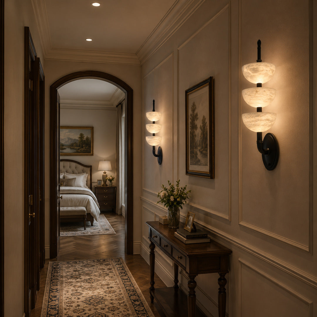 Row of Trio alabaster wall sconces adding warm rhythmic accents along a hallway