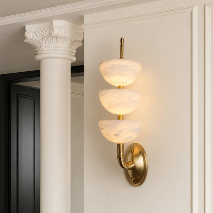 Trio alabaster wall sconce welcoming guests with a warm glow above an entry console