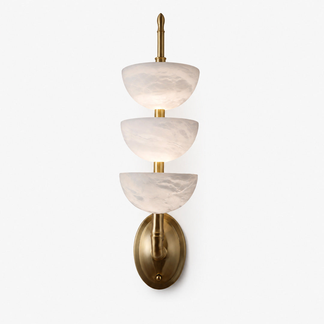 Brass-frame Trio alabaster wall sconce as a warm sculptural accent on a living room wall