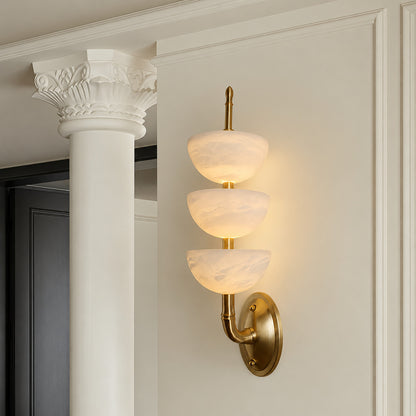 Trio alabaster wall sconce welcoming guests with a warm glow above an entry console