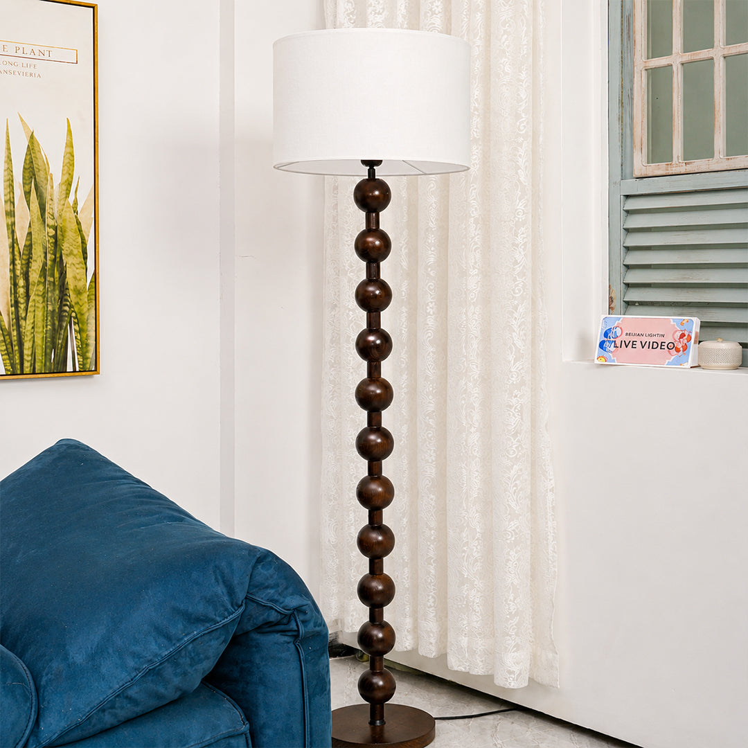 Tronco floor lamp nature wood modern living room reading chair beside accent tall 63 inch statement natural wood white fabric shade minimalist Scandinavian warm ambient intimate cozy lifestyle interior American home