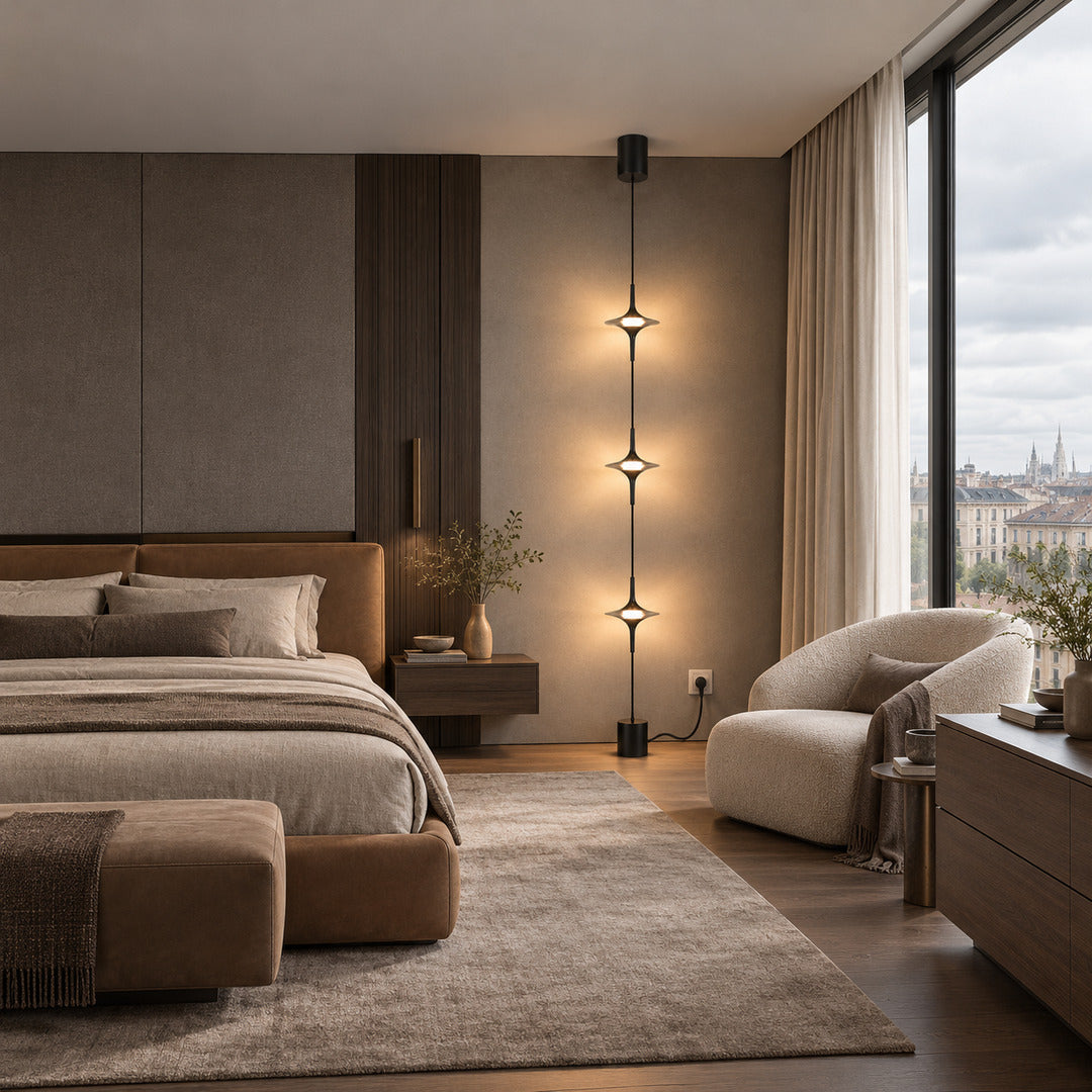 Black Trottola floor to ceiling lamp beside the bed casting soft star light over the nightstand