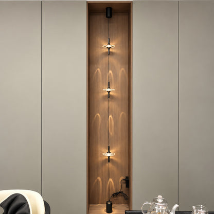 Black Trottola floor to ceiling lamp on a white wall in a minimalist modern interior