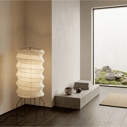 UF2-31N Washi paper table lamp with warm internal glow, handcrafted rice paper shade on black metal tripod legs.