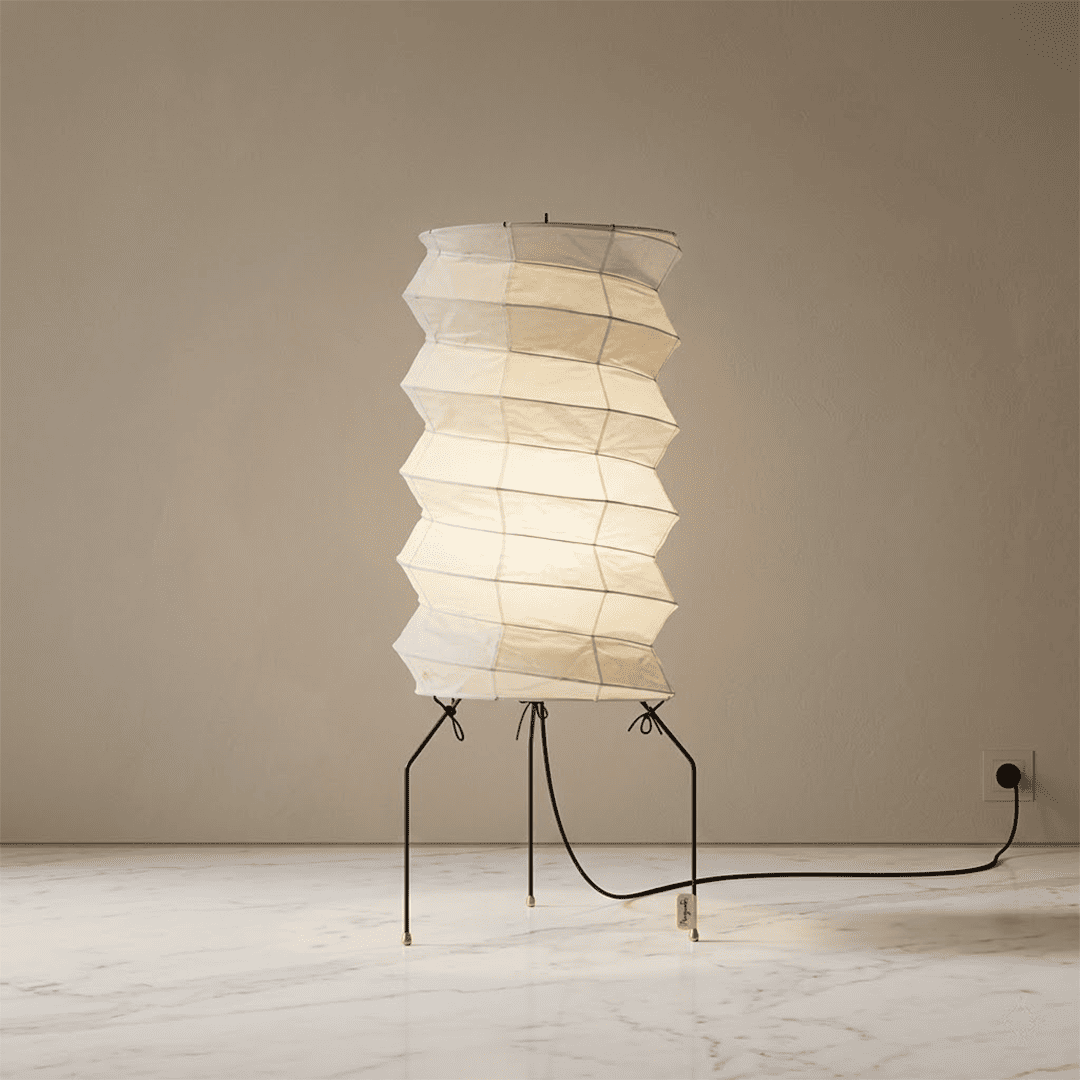UF2-31N Washi paper table lamp with warm internal glow, handcrafted rice paper shade on black metal tripod legs.