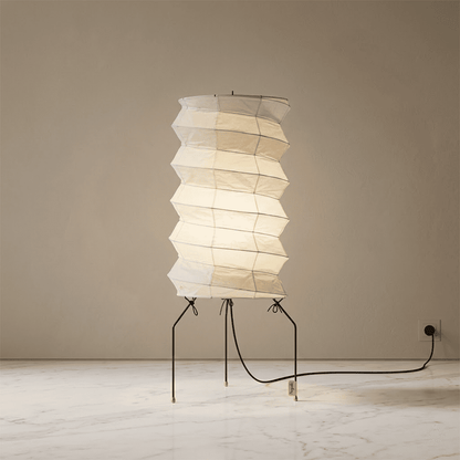 UF2-31N Washi paper table lamp with warm internal glow, handcrafted rice paper shade on black metal tripod legs.