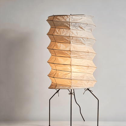 UF2-31N Washi paper table lamp with warm internal glow, handcrafted rice paper shade on black metal tripod legs.