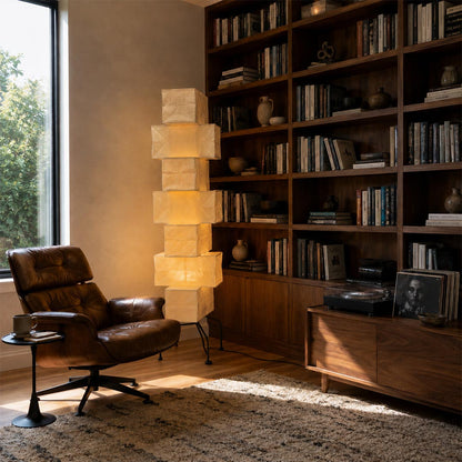 Japanese style UF4-L10 washi paper stacked tower floor lamp styled in a cozy home office library next to a leather armchair