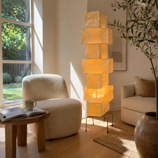 Warm soft lighting from a UF4-L10 washi paper stacked tower floor lamp in a modern minimalist living room lounge area