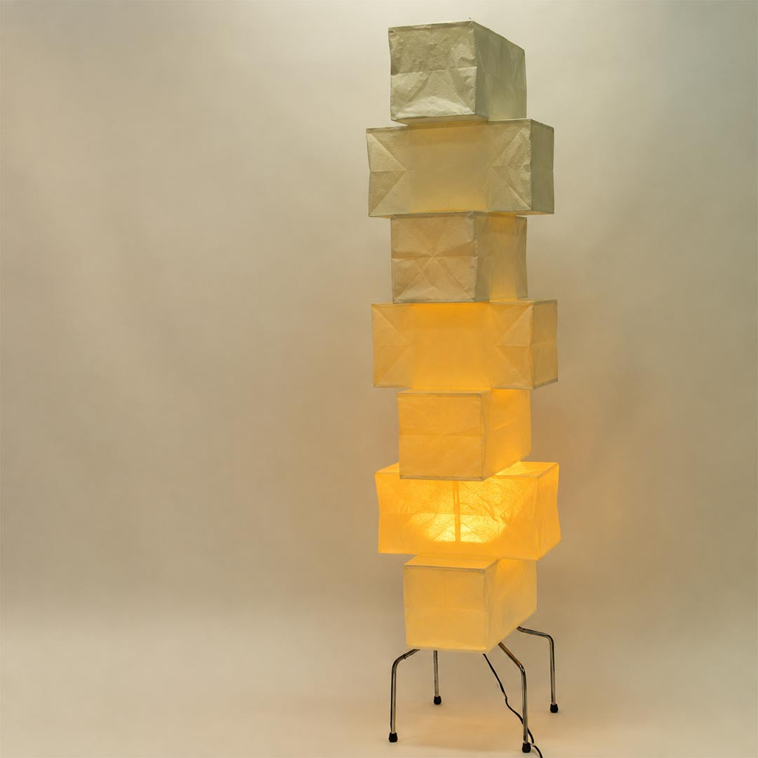 UF4-L10 washi paper stacked tower floor lamp illuminated against a plain background displaying a warm ambient glow