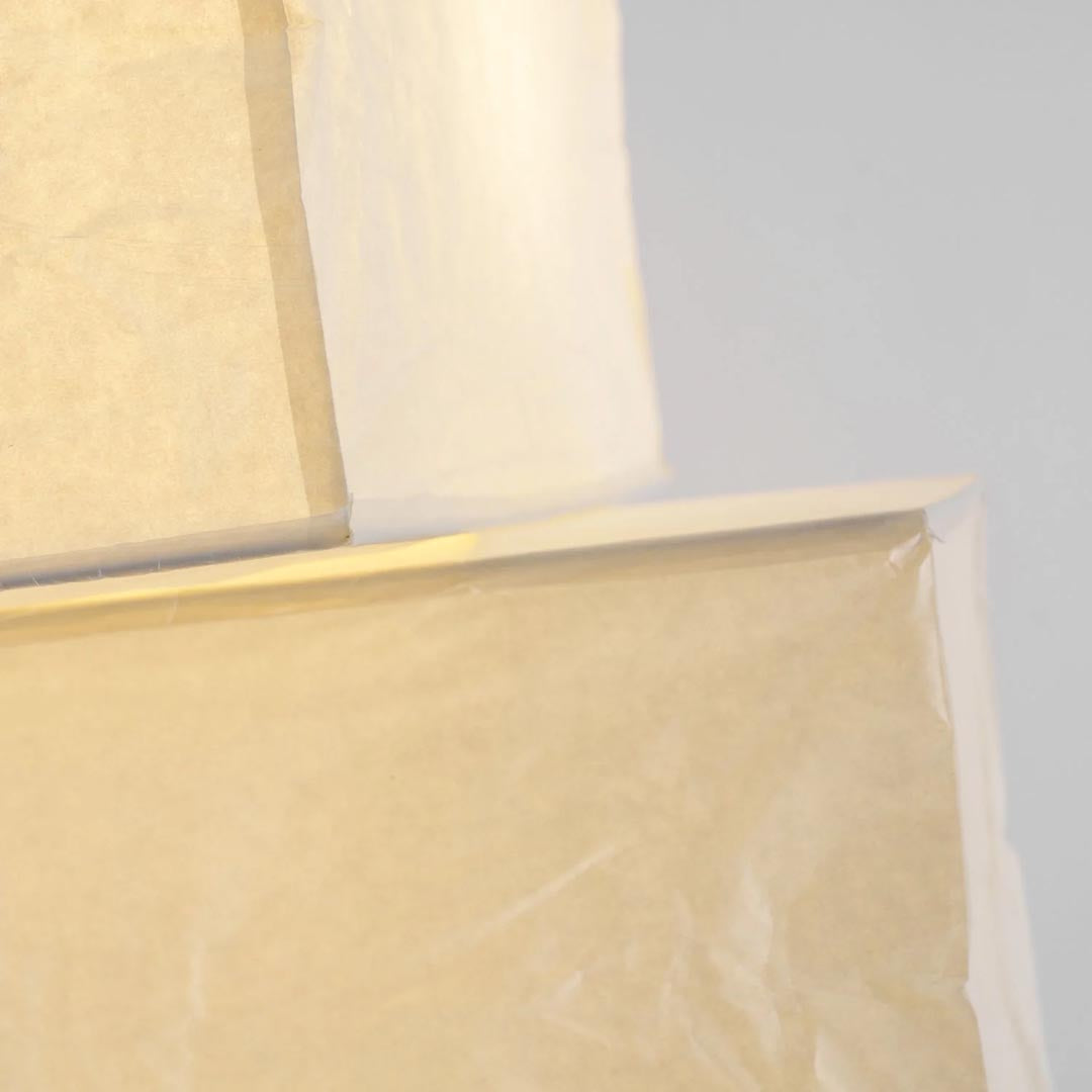 Macro close-up shot showing the organic handcrafted texture and wire frame of the UF4-L10 washi paper floor lamp