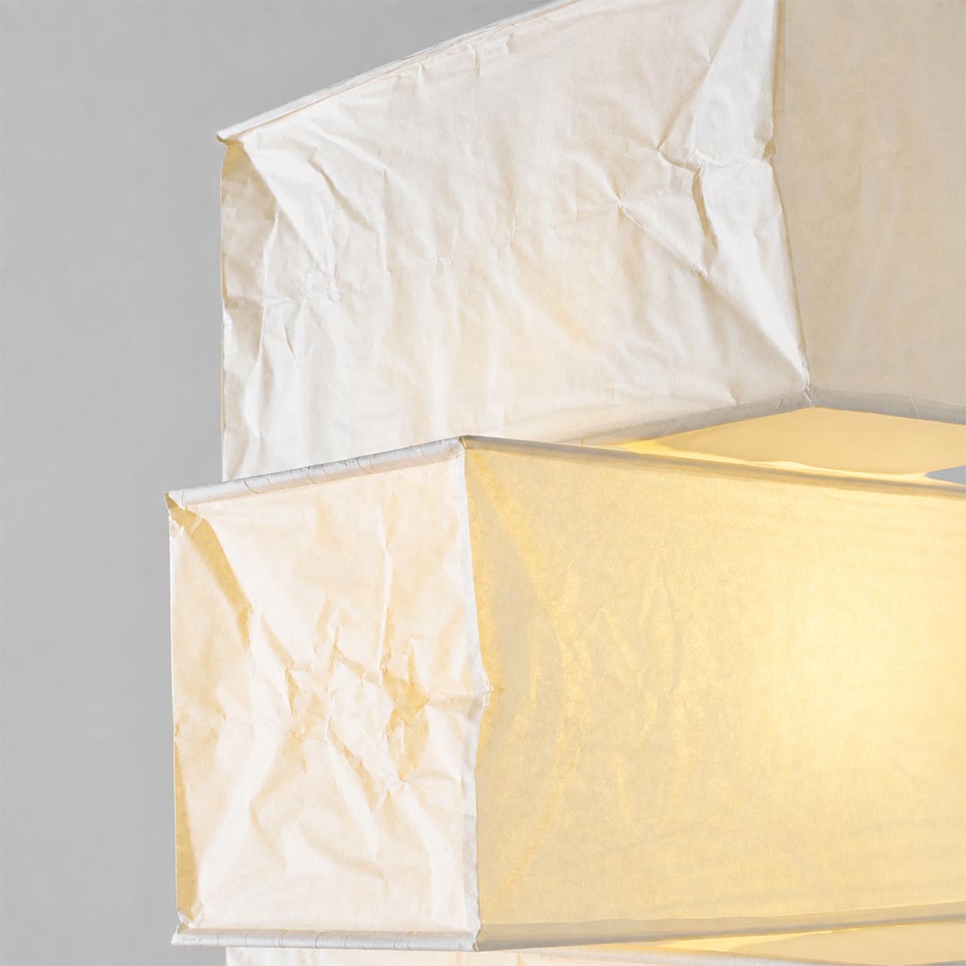 Close-up view of the stacked geometric paper shades on the UF4-L10 washi paper tower floor lamp