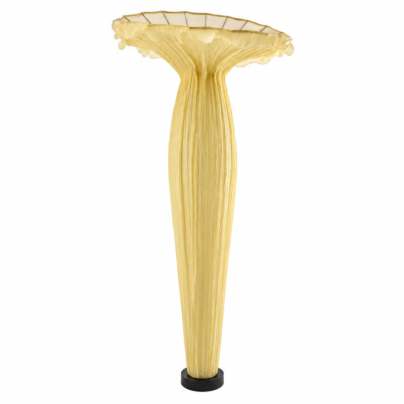Vaso fabric floor lamp with a sculptural vase-shaped shade glowing warm in a living room corner