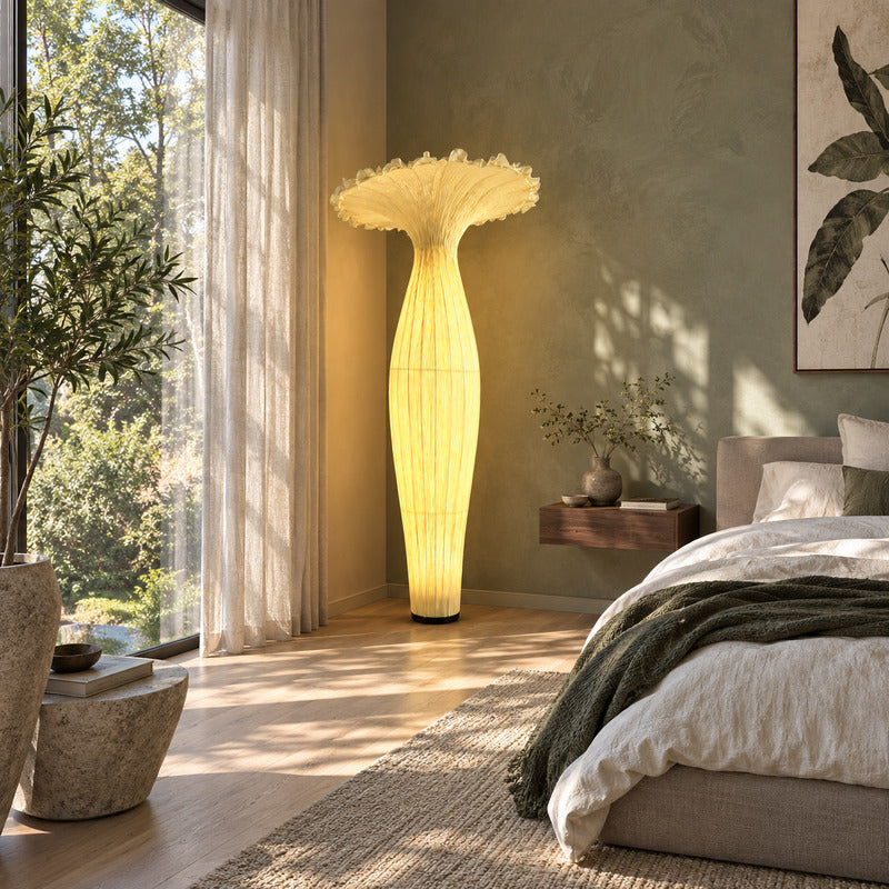 Vaso fabric floor lamp adding a warm soft glow beside a modern bedroom bed