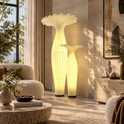 Vaso fabric floor lamp filling a dark living room corner with a soft warm glow from top to bottom