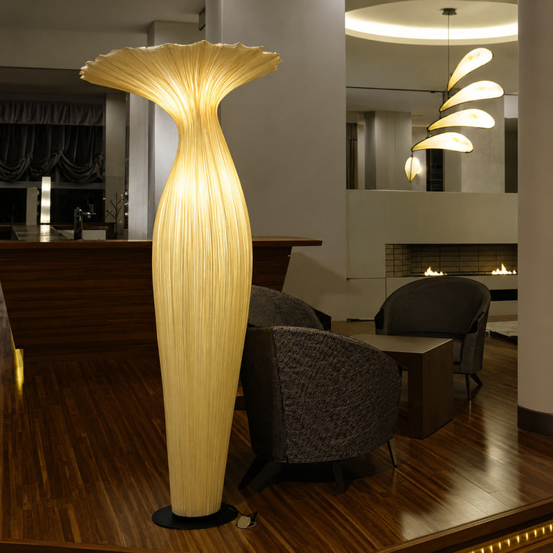 Vaso fabric floor lamp filling a dark living room corner with a soft warm glow from top to bottom